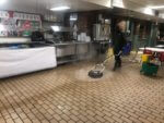 Service Technician Cleaning Restaurant Kitchen Floor