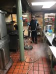 Service Technician Cleaning Restaurant Kitchen Floor