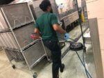 Service Technician Cleaning Restaurant Kitchen Floor