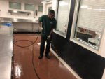 Service Technician Pressure Washing Restaurant Kitchen Floor